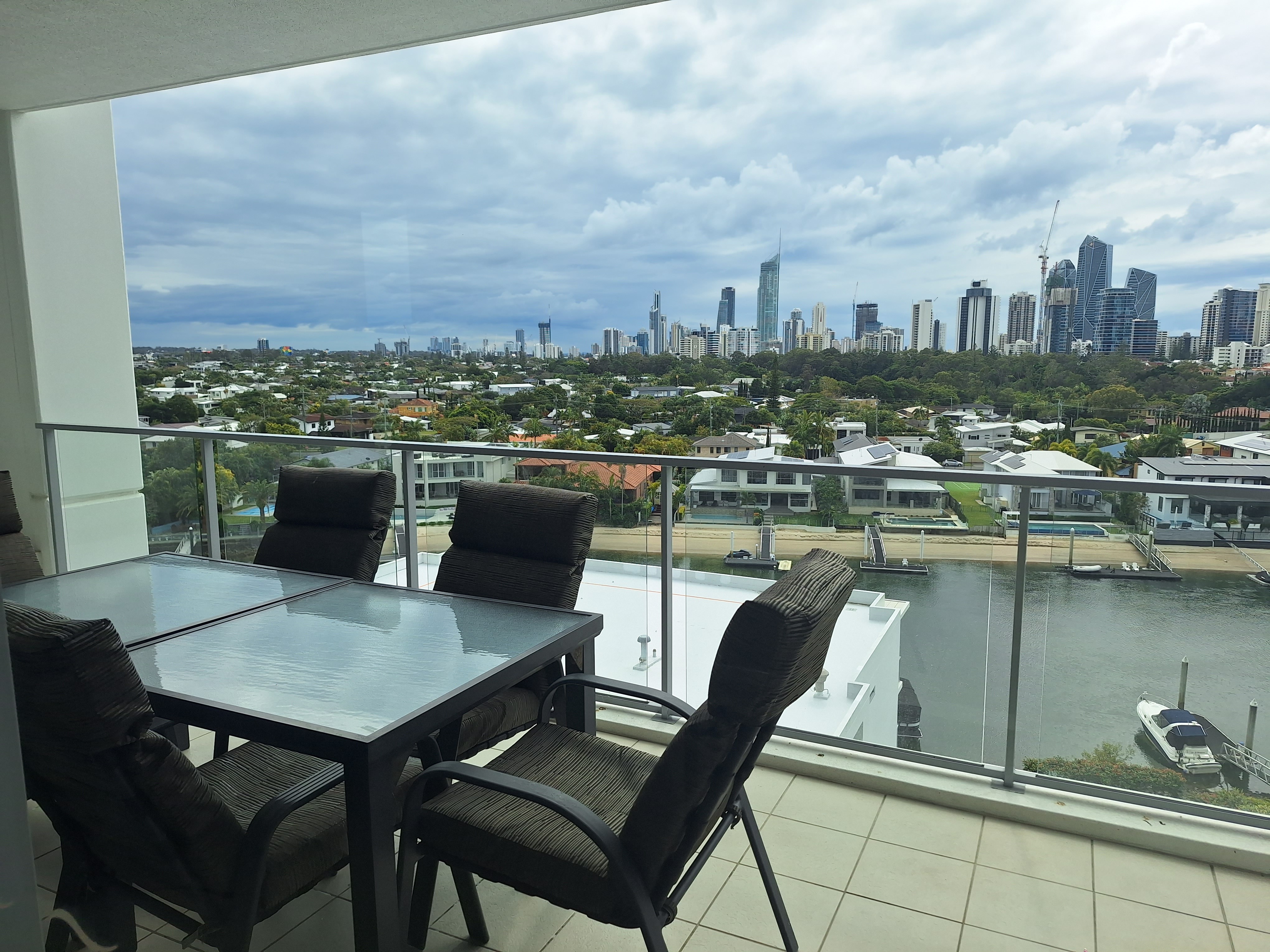 Balcony area with table and chairs and skyscraper city view